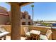 Charming balcony area with a table and chairs, a barbecue and views of community and palm trees at 1401 E Puget Ave # 10, Phoenix, AZ 85020