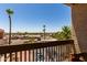 Expansive balcony view showcasing palm trees, city landscape and blue skies, with a wooden railing at 1401 E Puget Ave # 10, Phoenix, AZ 85020