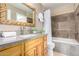 Well-maintained bathroom featuring stylish vanity, tiled walls, and a shower-tub combination at 1401 E Puget Ave # 10, Phoenix, AZ 85020