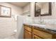 Stylish bathroom featuring a marble countertop, decorative mirror and textured white tile backsplash at 1401 E Puget Ave # 10, Phoenix, AZ 85020
