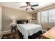 Cozy bedroom featuring a plush bed, ceiling fan and plenty of natural light from the window at 1401 E Puget Ave # 10, Phoenix, AZ 85020