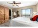 Comfortable bedroom with a ceiling fan, armoire, and a sliding glass door to the balcony with a view at 1401 E Puget Ave # 10, Phoenix, AZ 85020