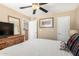 Spacious bedroom with a large window, ceiling fan, dresser and closet and a view into the bathroom at 1401 E Puget Ave # 10, Phoenix, AZ 85020