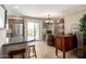 Dining area features a kitchen bar, chandelier, and sliding glass door access to a patio at 1401 E Puget Ave # 10, Phoenix, AZ 85020