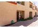 Townhouse exterior featuring a tan stucco facade, terracotta roof, and well-kept landscaping at 1401 E Puget Ave # 10, Phoenix, AZ 85020