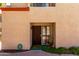 Exterior view of the townhouse showcases its neutral stucco facade and tiled roofline at 1401 E Puget Ave # 10, Phoenix, AZ 85020