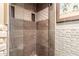 Modern shower with textured tile walls, a recessed shelf and glass doors to maximize light at 1401 E Puget Ave # 10, Phoenix, AZ 85020