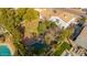 Aerial view of the property with a backyard pool, landscaped yard with mature trees, and well-maintained lawn at 15806 N 45Th Pl, Phoenix, AZ 85032