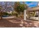 View of a backyard with covered patio, pool, gravel landscaping, and lush trees at 15806 N 45Th Pl, Phoenix, AZ 85032