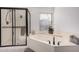 Bright bathroom featuring a walk-in shower, soaking tub, and large window at 15806 N 45Th Pl, Phoenix, AZ 85032