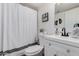 Cozy bathroom features a white vanity, modern fixtures, and a shower with a stylish curtain at 15806 N 45Th Pl, Phoenix, AZ 85032