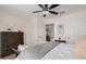 Bright bedroom showcasing a ceiling fan, dresser, and comfortable bed with decorative pillows and blankets at 15806 N 45Th Pl, Phoenix, AZ 85032