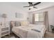Cozy bedroom featuring a comfortable bed, soft lighting, and a ceiling fan at 15806 N 45Th Pl, Phoenix, AZ 85032