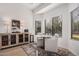 Bright breakfast nook features a stylish cabinet, seating for two, and a view of the outdoors at 15806 N 45Th Pl, Phoenix, AZ 85032