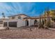 Beautiful property showcasing desert landscaping, a private balcony, and a spacious three-car garage at 15806 N 45Th Pl, Phoenix, AZ 85032