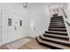 Bright foyer featuring wood flooring, a staircase, and an inviting front door at 15806 N 45Th Pl, Phoenix, AZ 85032