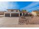 Inviting two-story home featuring a balcony, beautiful desert landscaping, and a spacious three-car garage at 15806 N 45Th Pl, Phoenix, AZ 85032