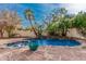 Backyard pool and spa surrounded by lush tropical landscaping and stone accents at 15806 N 45Th Pl, Phoenix, AZ 85032
