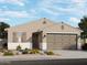Inviting single-story home featuring a neutral palette, a two-car garage, and low-maintenance landscaping at 15928 W Gray Fox Trl, Surprise, AZ 85387