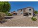 Two-story home backyard, with desert landscaping, under a clear blue sky at 17471 W Watson Ln, Surprise, AZ 85388