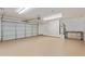 Spacious garage with epoxy flooring, side sink and storage, and automatic door at 17471 W Watson Ln, Surprise, AZ 85388