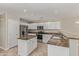 Bright kitchen with white cabinetry, stainless steel appliances, and a center island at 17471 W Watson Ln, Surprise, AZ 85388