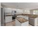 Modern kitchen featuring white cabinets, granite countertops and stainless steel appliances at 17471 W Watson Ln, Surprise, AZ 85388