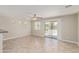 Bright living room with tile floors and sliding glass doors to the backyard at 17471 W Watson Ln, Surprise, AZ 85388