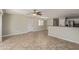 Spacious living room with tile floors, neutral walls and an open layout to the kitchen at 17471 W Watson Ln, Surprise, AZ 85388