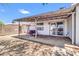 Covered backyard patio featuring a swing and sliding glass door leading indoors at 1858 S Ocotillo Dr, Apache Junction, AZ 85120