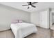 Minimalist bedroom featuring a ceiling fan, light gray walls, and tiled floors at 1858 S Ocotillo Dr, Apache Junction, AZ 85120
