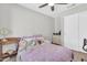 Cozy bedroom features light gray walls, a ceiling fan, and sliding closet doors at 1858 S Ocotillo Dr, Apache Junction, AZ 85120
