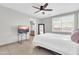 Bright bedroom featuring a ceiling fan, a television, and an attached bathroom at 1858 S Ocotillo Dr, Apache Junction, AZ 85120