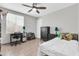 Bedroom features tiled floors, a ceiling fan, and a large window at 1858 S Ocotillo Dr, Apache Junction, AZ 85120