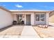 Welcoming front porch with seating, desert landscaping, and a secure screen door for added peace of mind at 1858 S Ocotillo Dr, Apache Junction, AZ 85120