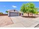 Cozy single-story home with a two-car garage, easy-care landscaping, and a bright, sunny facade at 1858 S Ocotillo Dr, Apache Junction, AZ 85120