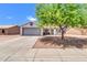 Charming single-story home with a two-car garage, mature tree, and low maintenance desert landscaping at 1858 S Ocotillo Dr, Apache Junction, AZ 85120