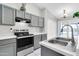 The kitchen features gray cabinets, tile flooring, and stainless steel appliances at 1858 S Ocotillo Dr, Apache Junction, AZ 85120