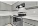 Close-up of the kitchen featuring stainless steel appliances and grey cabinetry at 1858 S Ocotillo Dr, Apache Junction, AZ 85120