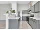 Kitchen with stainless steel appliances, gray cabinets, and a breakfast bar at 1858 S Ocotillo Dr, Apache Junction, AZ 85120