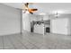 Open living room with tile flooring, ceiling fan, and view into the kitchen at 1858 S Ocotillo Dr, Apache Junction, AZ 85120