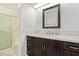 Bathroom with white countertop, dark wood vanity, and framed mirror above the sink at 1905 E University Dr # 139, Tempe, AZ 85288