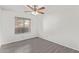 A bedroom featuring wood-look flooring, a ceiling fan, and a window with blinds at 1905 E University Dr # 139, Tempe, AZ 85288