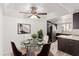 Cozy dining room with a glass table, stylish seating, and a view into the adjacent updated kitchen at 1905 E University Dr # 139, Tempe, AZ 85288