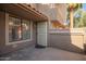 Inviting condo entrance featuring a secure door, textured walls, and a window allowing ample natural light at 1905 E University Dr # 139, Tempe, AZ 85288