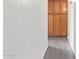 Hallway featuring wood-look flooring and a wall of wooden storage cabinets at 1905 E University Dr # 139, Tempe, AZ 85288