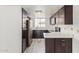 Contemporary kitchen featuring dark wood cabinets, stainless steel appliances, and bright quartz countertops at 1905 E University Dr # 139, Tempe, AZ 85288