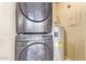 Stacked washer and dryer with adjacent water heater and circuit breaker at 1905 E University Dr # 139, Tempe, AZ 85288