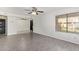 Spacious living room with modern flooring, a ceiling fan, and a view into the adjacent dining area at 1905 E University Dr # 139, Tempe, AZ 85288