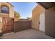 Private condo patio featuring a gated entrance and an enclosed storage area, perfect for outdoor living at 1905 E University Dr # 139, Tempe, AZ 85288